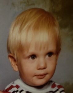 a portrait of a blonde haired toddler