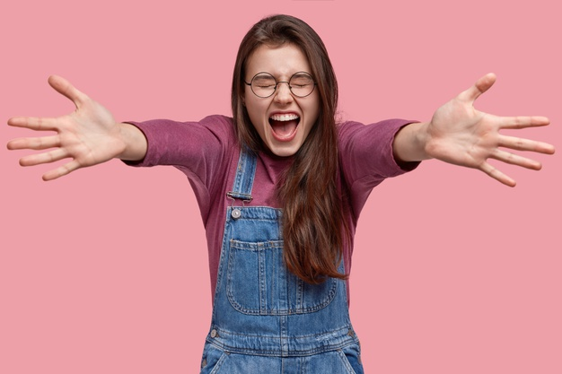 an excited woman with arms outstretched for a hug
